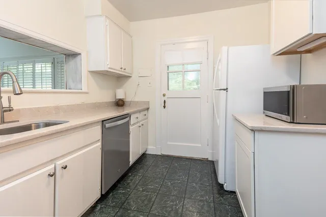 a kitchen with a sink and cabinets
