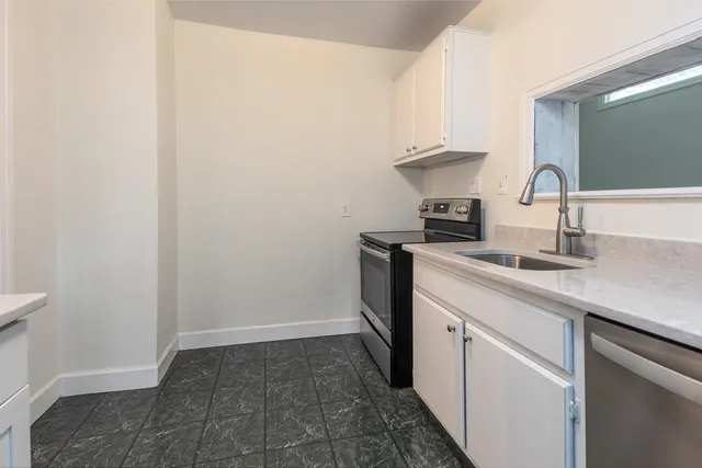 a kitchen with a sink and cabinets
