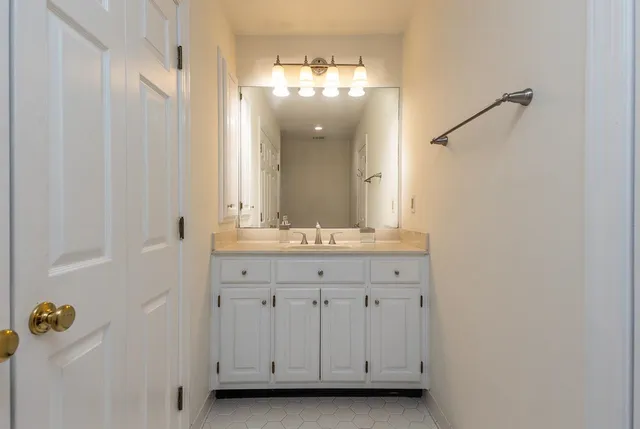 a bathroom with a sink and mirror