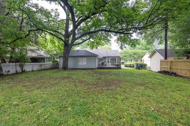 a front view of house with a garden
