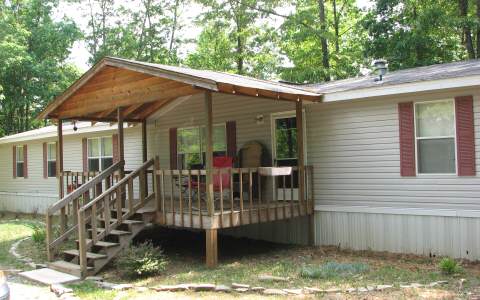 180 Hicks Ford Road Ellijay, GA 30540 - Photo 1 of 1 a view of a house with backyard and sitting area