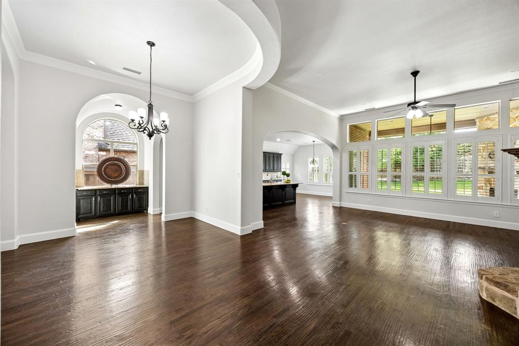 1567 Red Rock Canyon Road Frisco, TX 75036 - Photo 13 of 36 Banks of windows, curved ceilings, crown molding & plantation shutters elevate the look of the living space.
