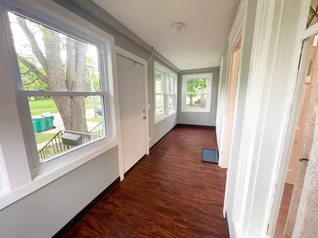 a view of an entryway with wooden floor and windows