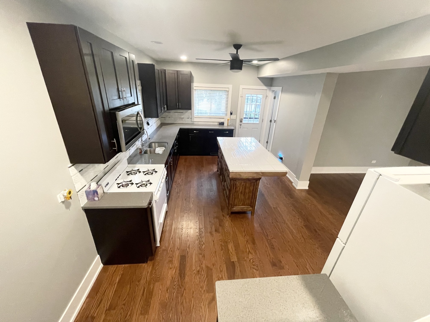 604 Clement Street Joliet, IL 60435 - Photo 4 of 14 a living room with a couch a dining table and chairs