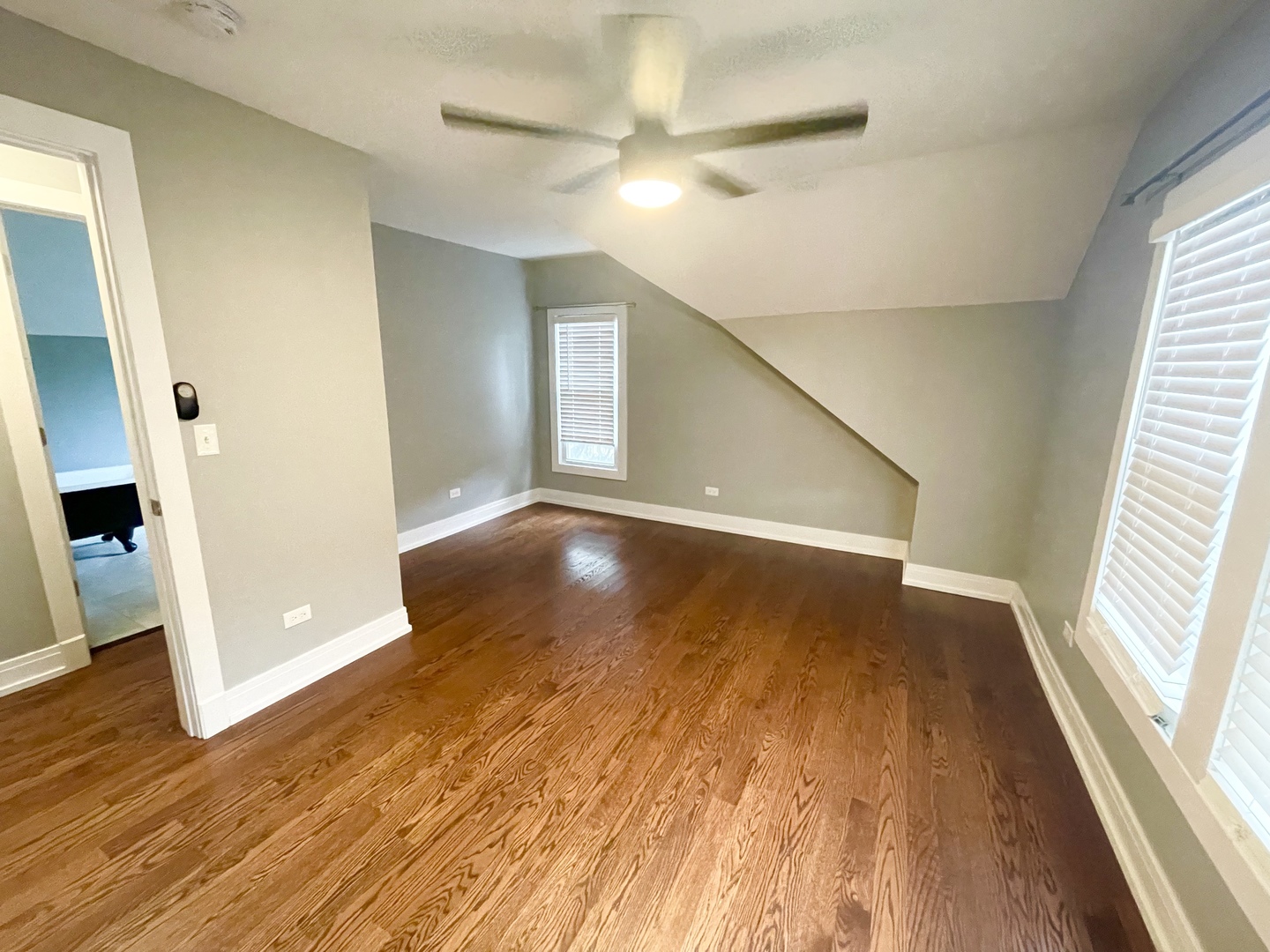604 Clement Street Joliet, IL 60435 - Photo 8 of 14 wooden floor in an empty room with a window