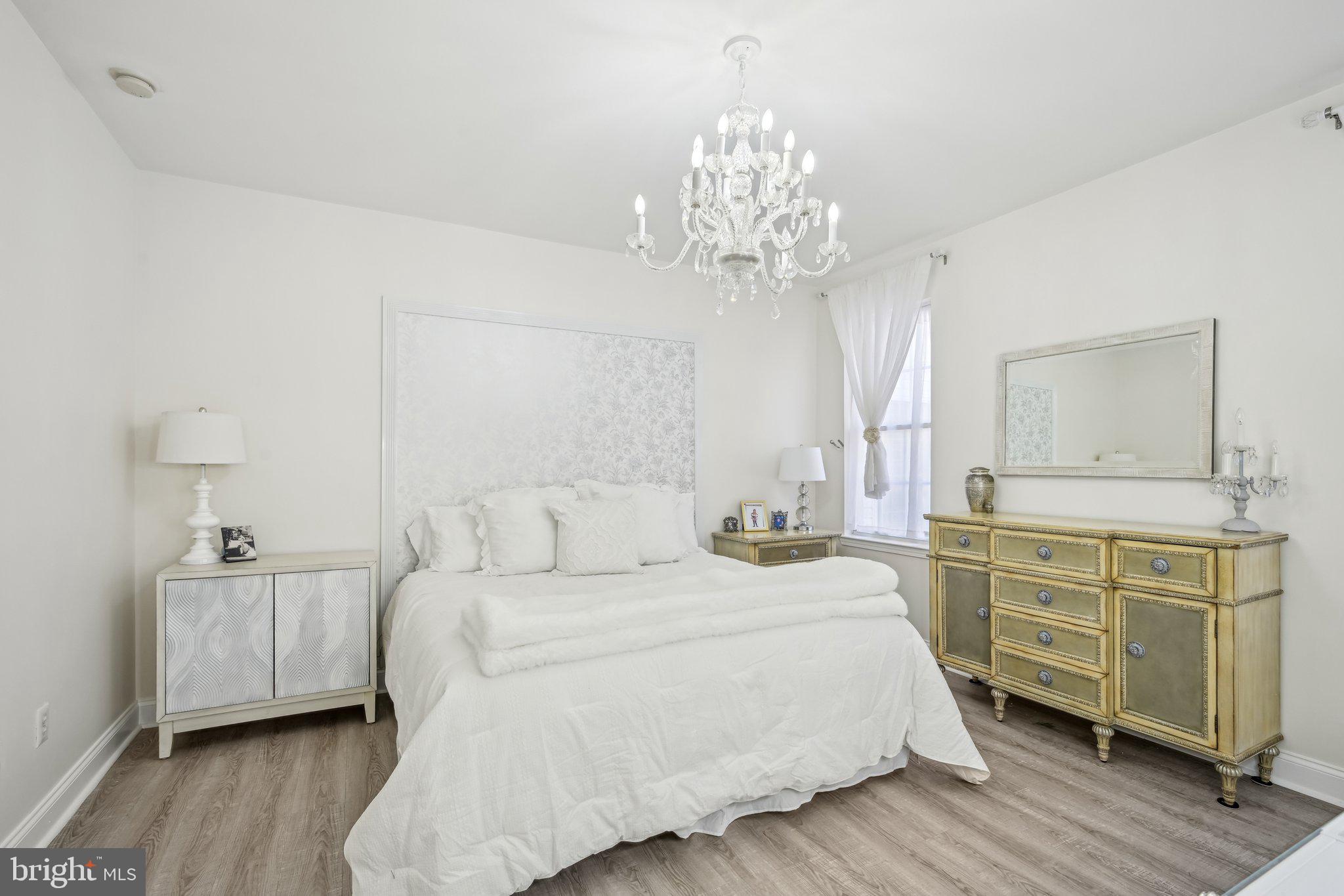 13 Carriage Berlin, NJ 08009 - Photo 21 of 41 a bedroom with a bed and a chandelier