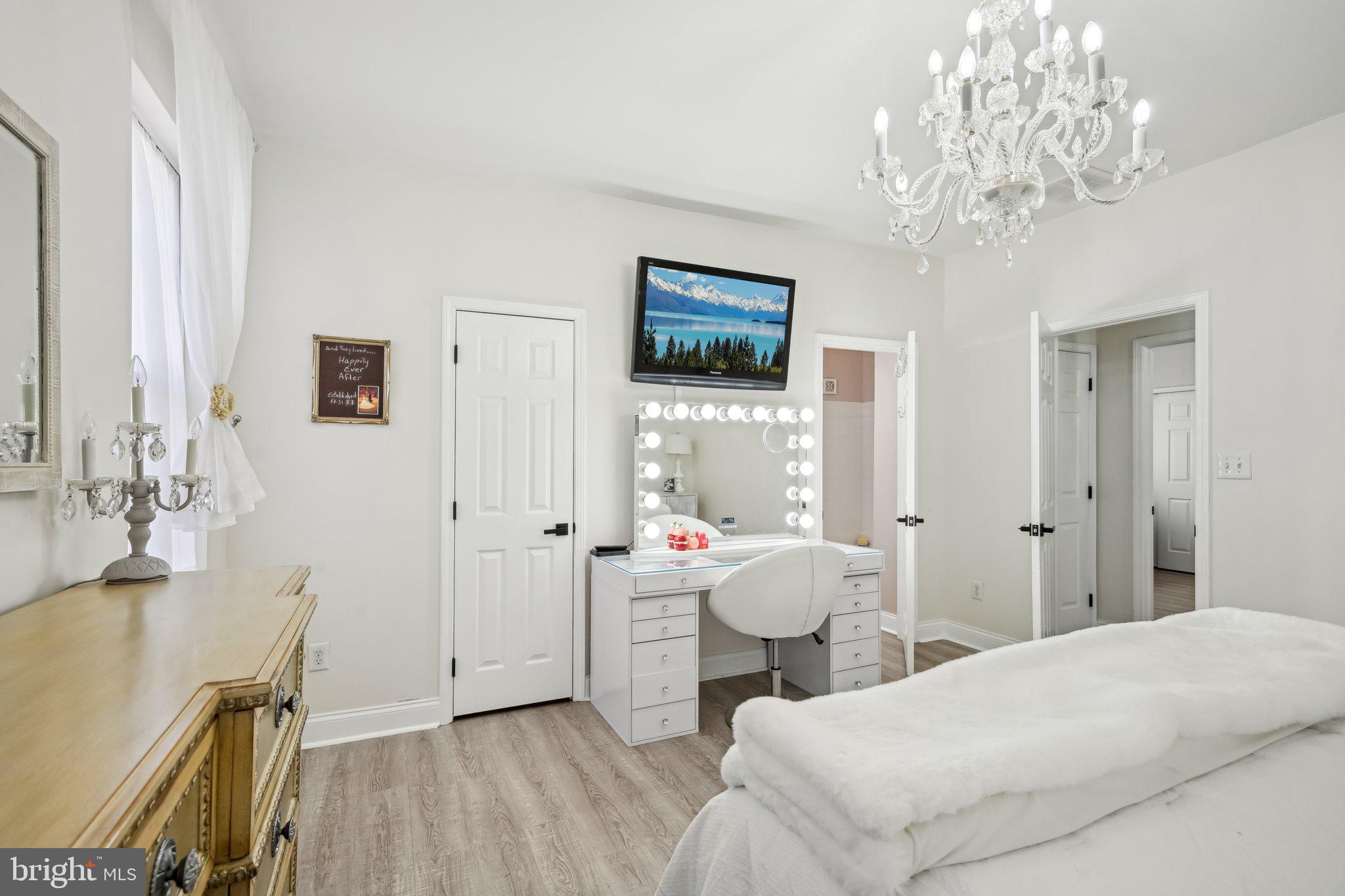 13 Carriage Berlin, NJ 08009 - Photo 22 of 41 a spacious bedroom with a bed and a chandelier