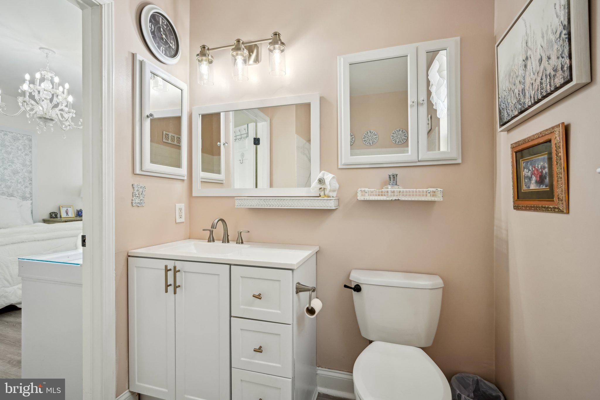 13 Carriage Berlin, NJ 08009 - Photo 26 of 41 a bathroom with a toilet a sink and mirror
