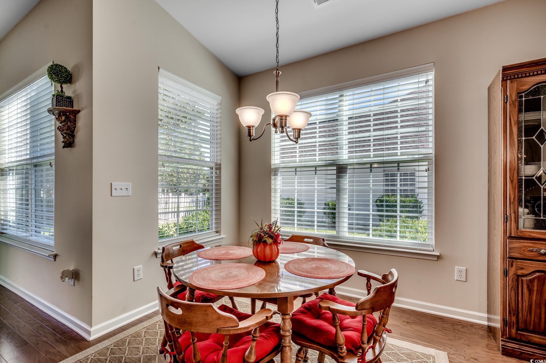 202 Fox Den Drive Murrells Inlet, SC 29576 - Photo 14 of 35 Dining room featuring light wood-style floors, plenty of natural light, and a chandelier