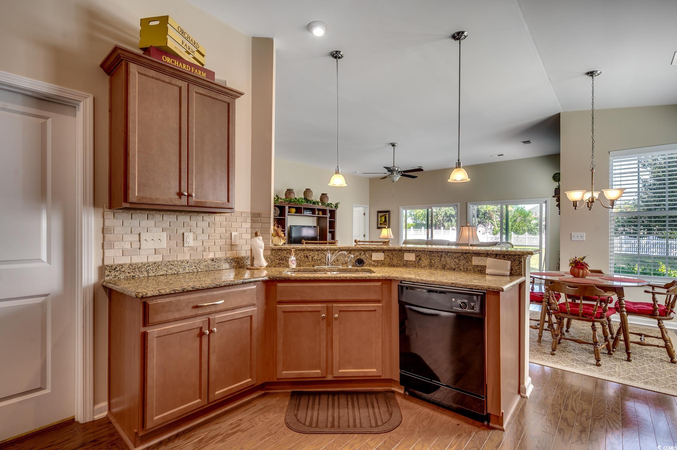 202 Fox Den Drive Murrells Inlet, SC 29576 - Photo 17 of 35 Kitchen with a peninsula, tasteful backsplash, decorative light fixtures, and dishwasher