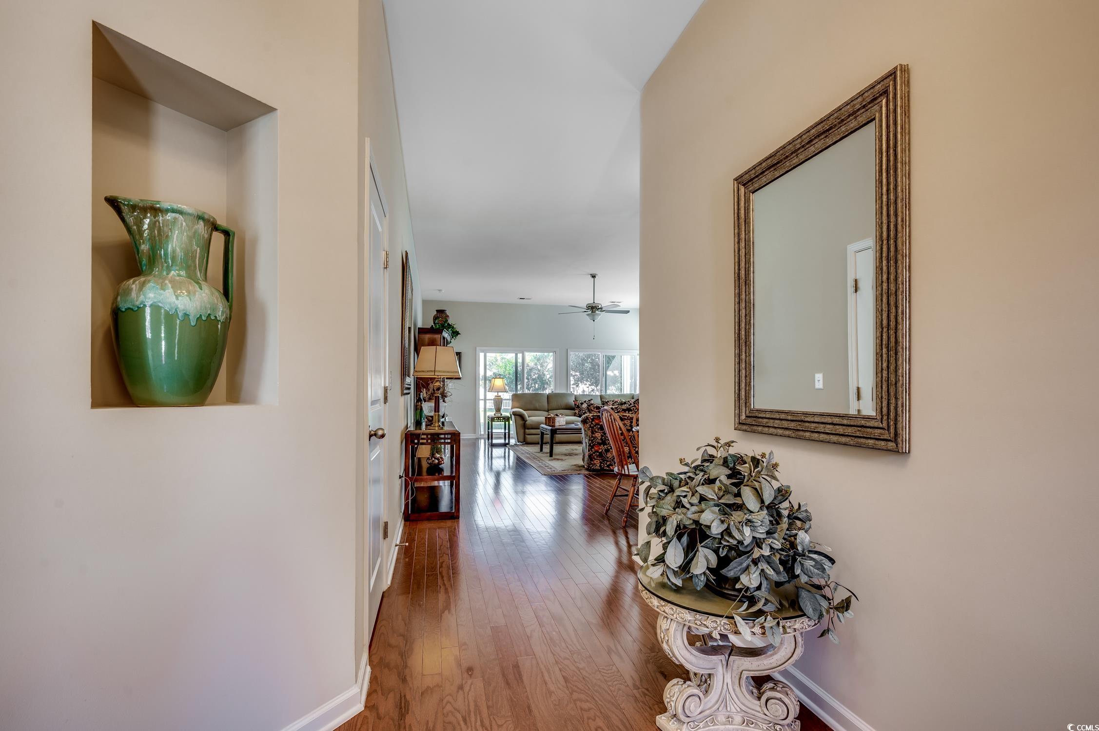 202 Fox Den Drive Murrells Inlet, SC 29576 - Photo 6 of 35 Hallway featuring wood finished floors and baseboards