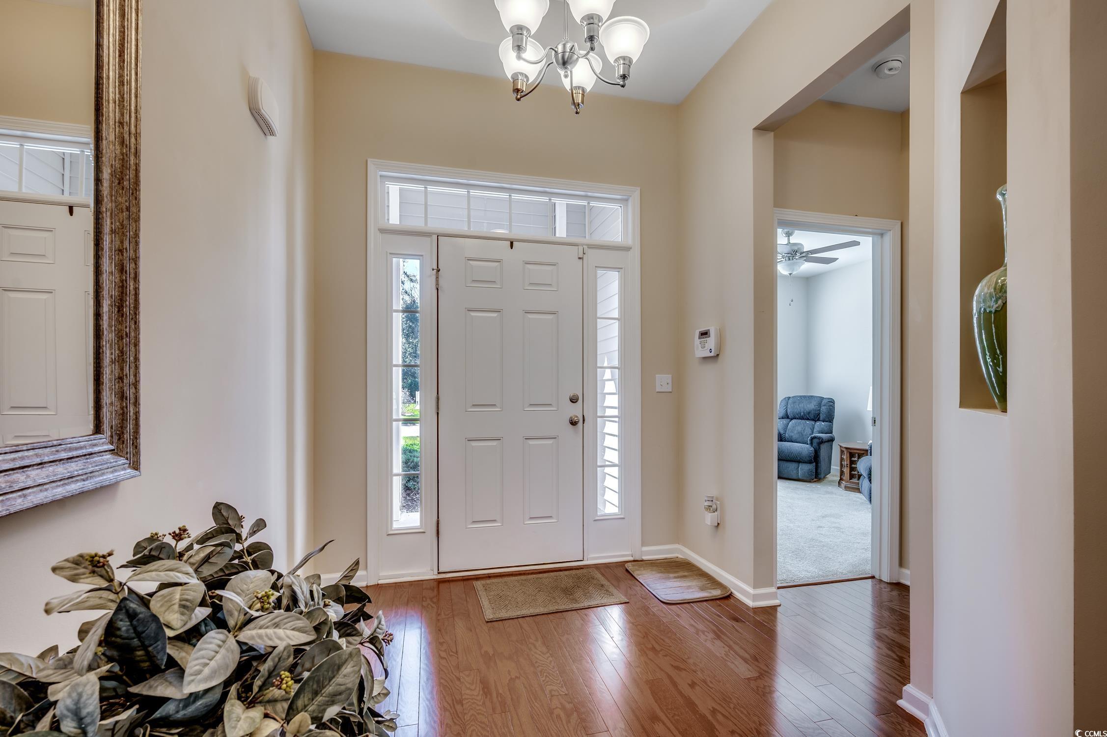 202 Fox Den Drive Murrells Inlet, SC 29576 - Photo 7 of 35 Entrance foyer featuring hardwood / wood-style flooring, ceiling fan, and a chandelier