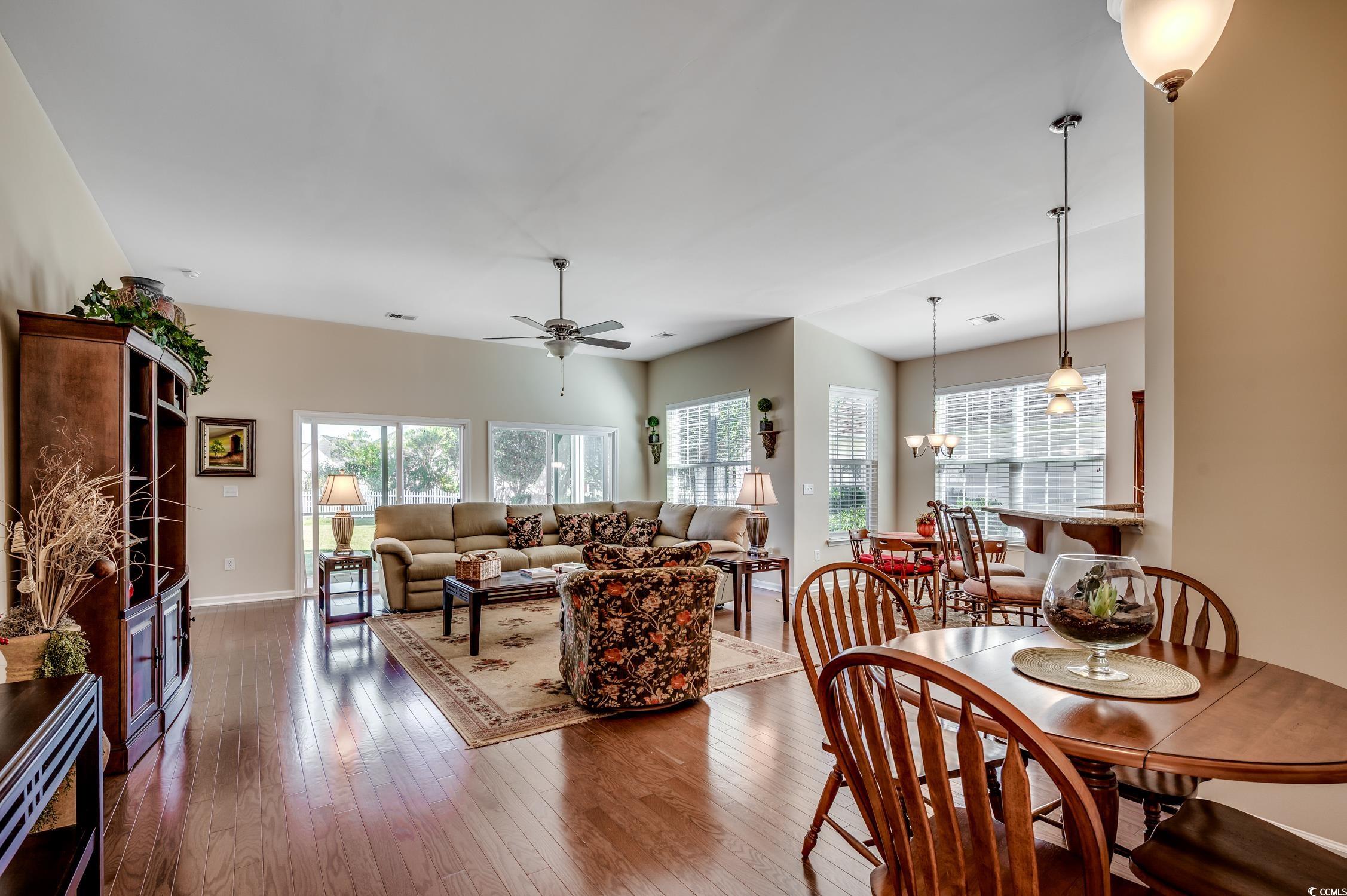 202 Fox Den Drive Murrells Inlet, SC 29576 - Photo 8 of 35 Dining area featuring ceiling fan, hardwood / wood-style floors, and a chandelier