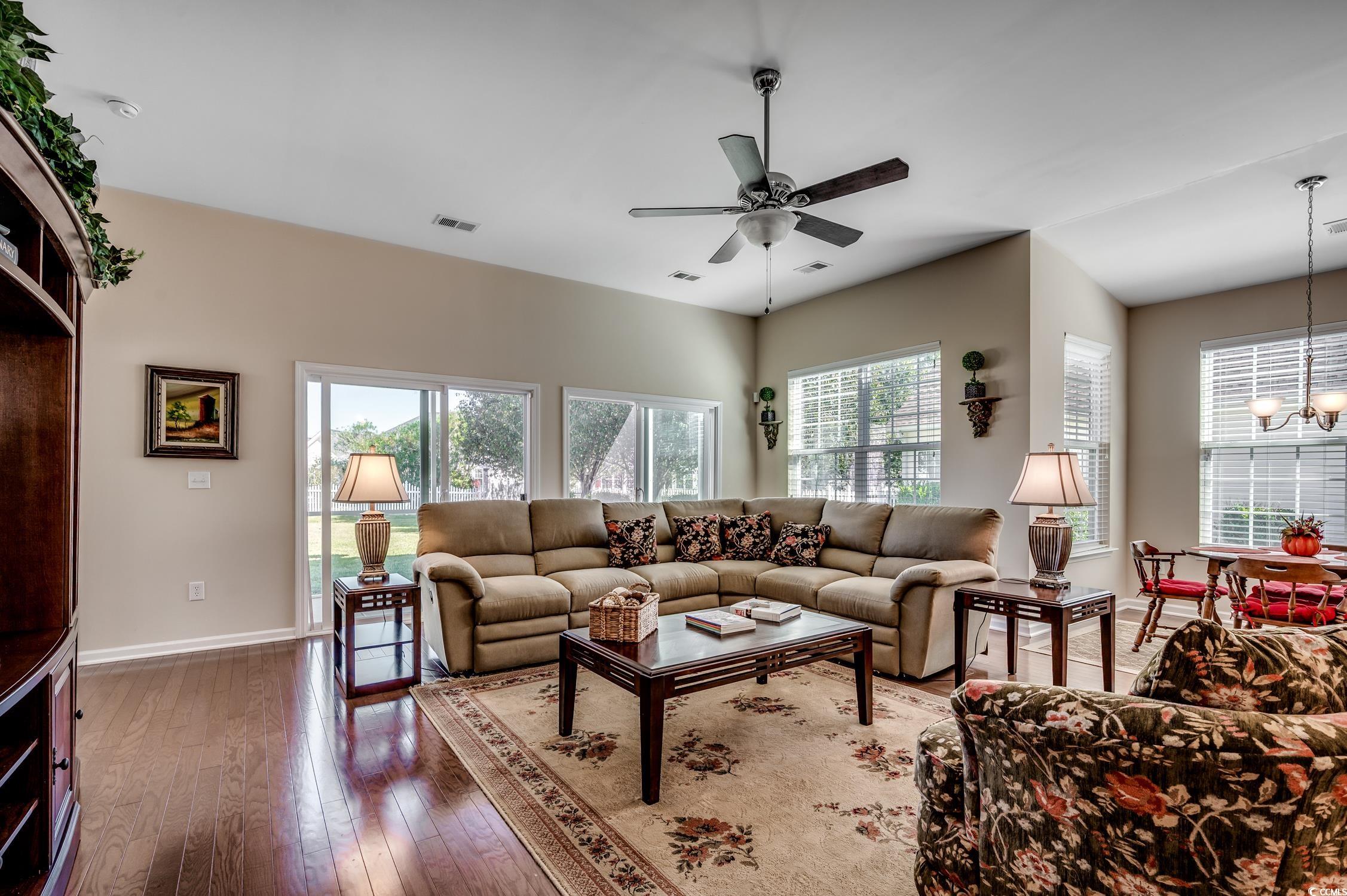 202 Fox Den Drive Murrells Inlet, SC 29576 - Photo 9 of 35 Living area with wood-type flooring, a chandelier, and a ceiling fan