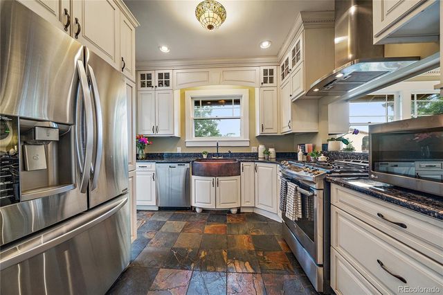 a kitchen with stainless steel appliances a refrigerator sink and stove