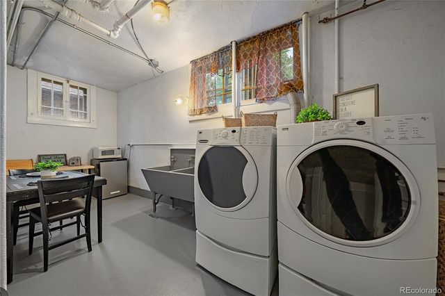 a view of workspace with table and paintings