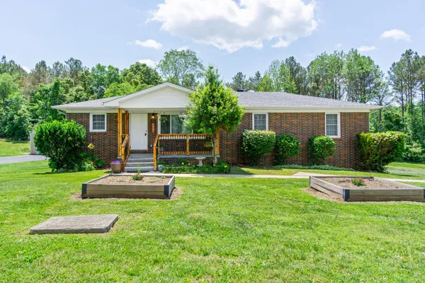 a front view of house with yard and outdoor seating