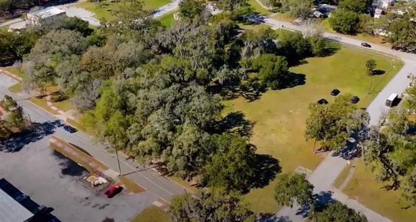 an aerial view of a house with a yard