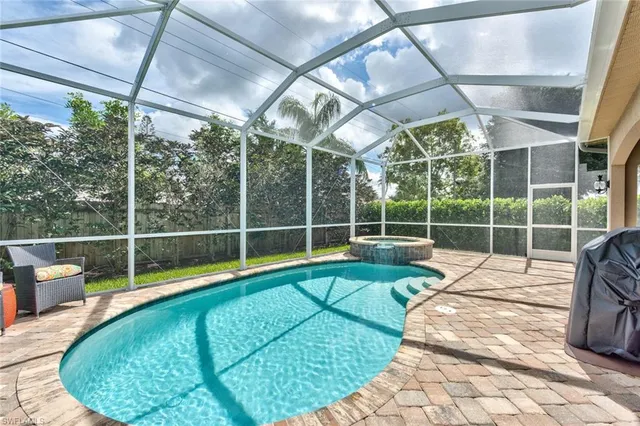 a view of a swimming pool with a patio and yard