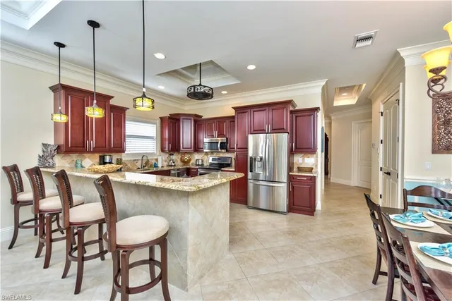 a large kitchen with a table and chairs