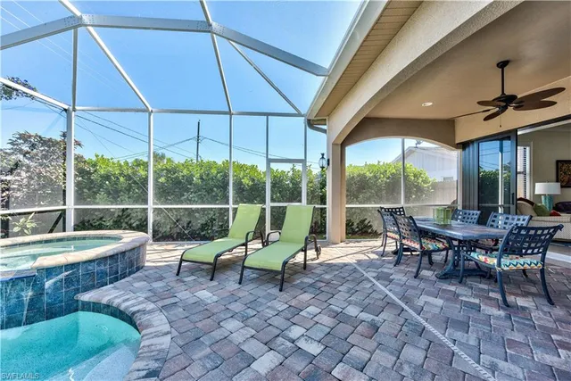 a view of a patio with table and chairs under an umbrella