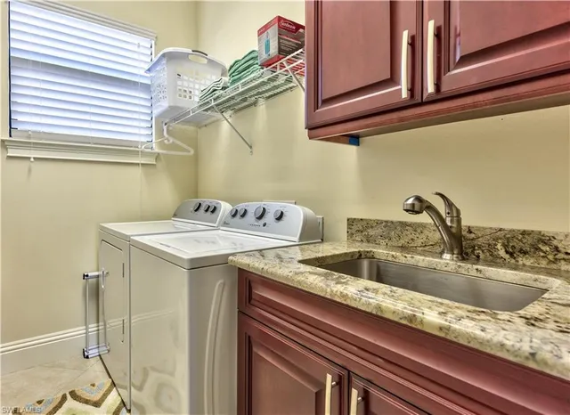 a view of a kitchen sink with a granite countertop