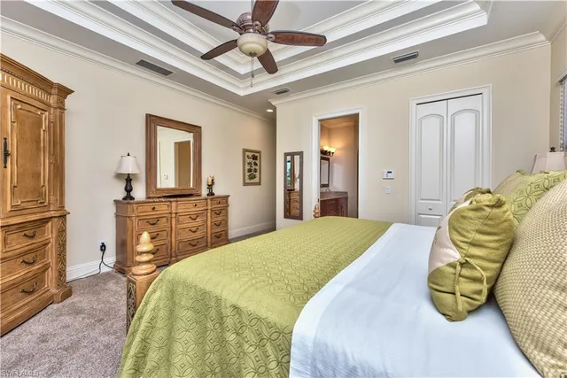 a bedroom with a bed and dresser with mirror