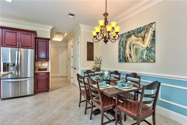 a view of a dining room with furniture a chandelier and wooden floor
