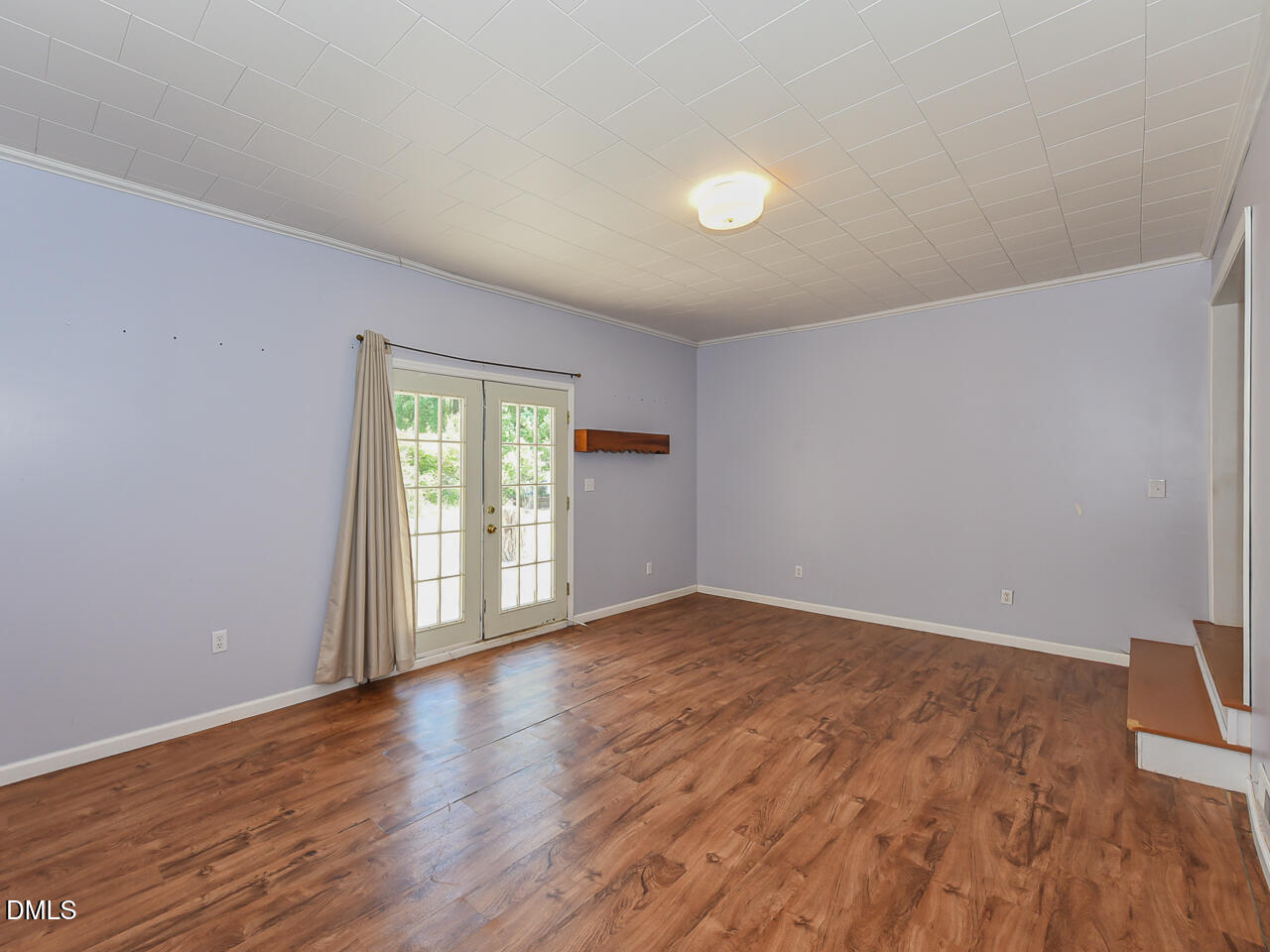 1703 St Patrick Drive Raleigh, NC 27603 - Photo 12 of 29 a view of an empty room with wooden floor and a window