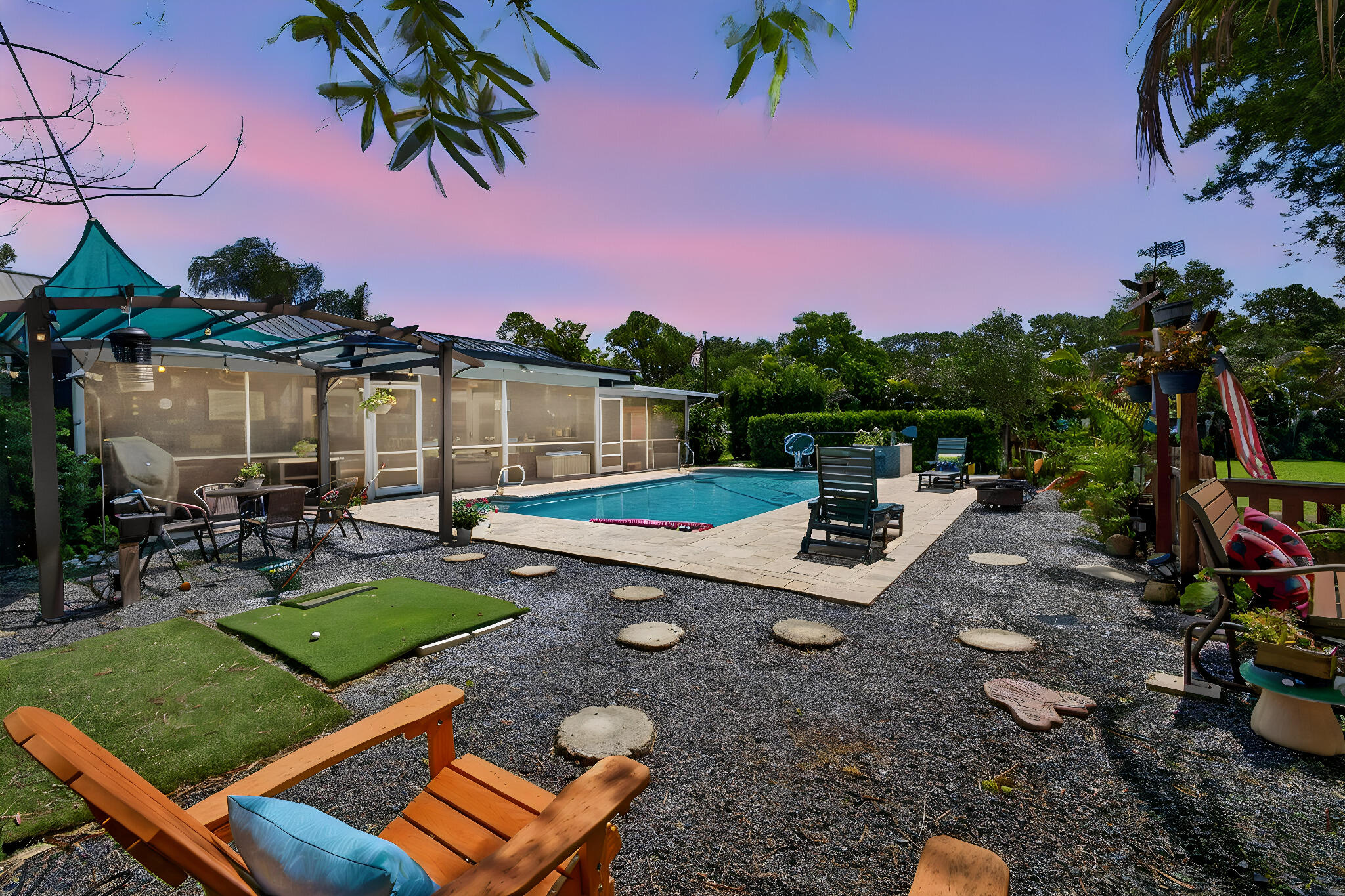 12558 165th Road North Jupiter, FL 33478 - Photo 42 of 67 a view of a backyard with couches and swimming pool
