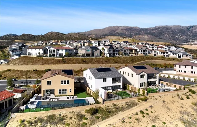 an aerial view of residential houses and car parked