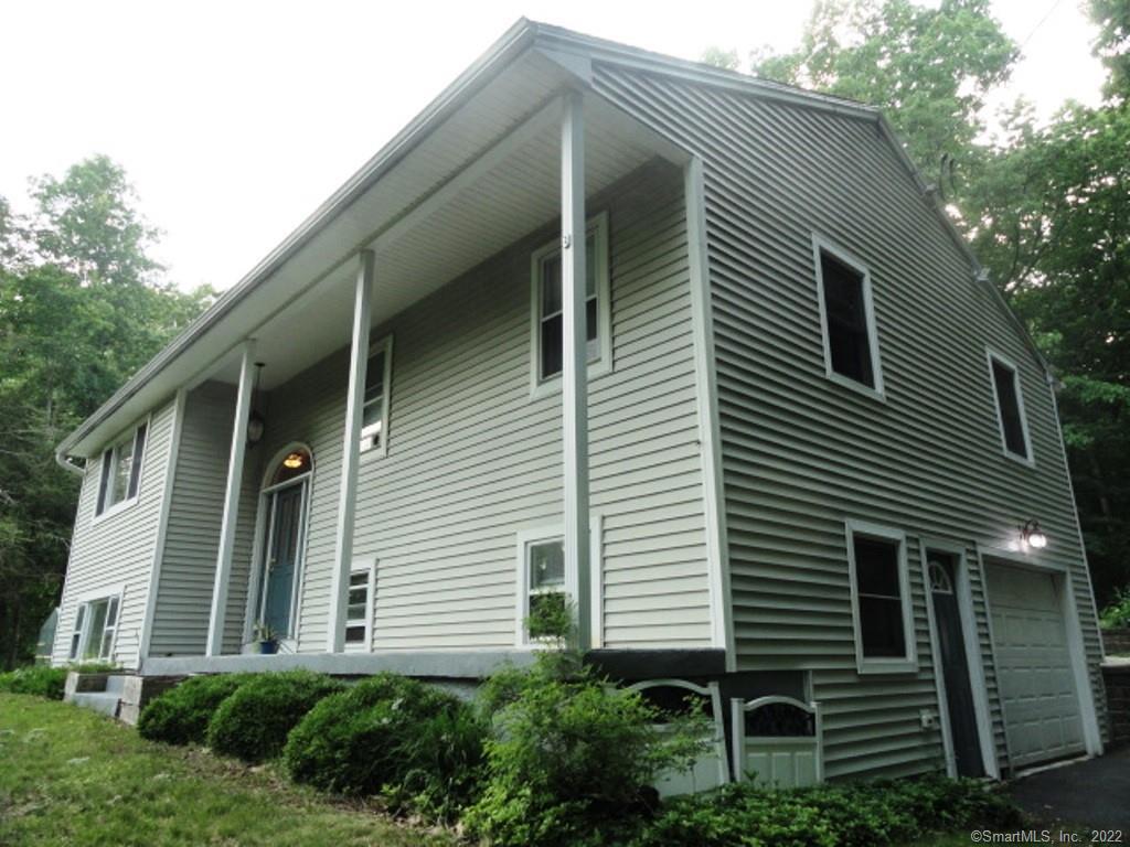 29 Snipsic Lake Road Ellington, CT 06029 - Photo 1 of 1 a view of a house with a yard and garage