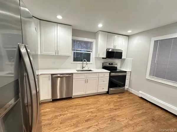 a kitchen with stainless steel appliances granite countertop a refrigerator sink and microwave
