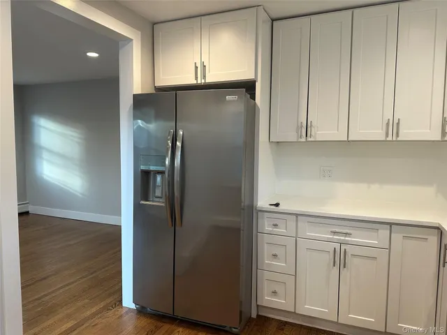 a kitchen with cabinets and stainless steel appliances