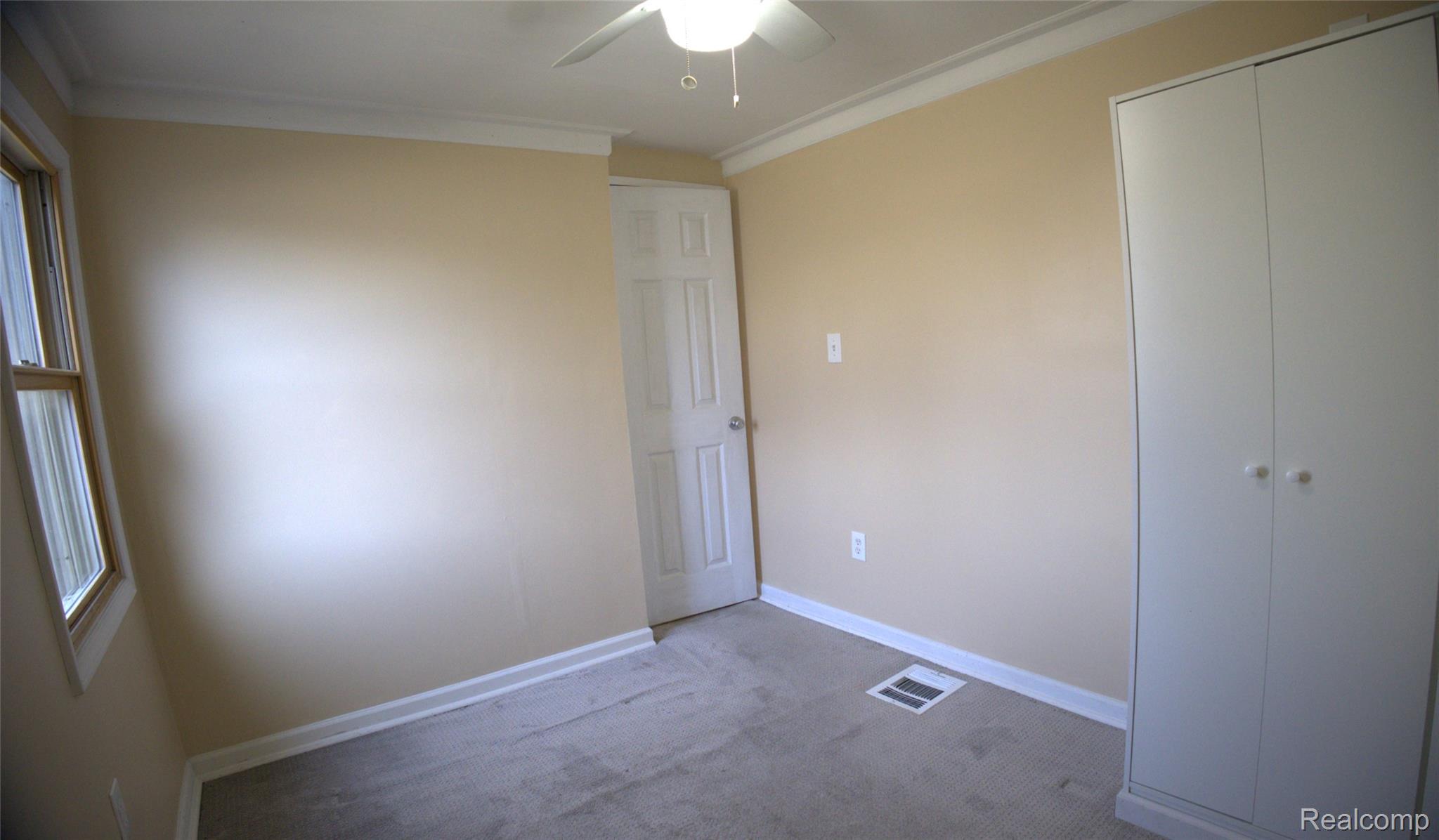 15676 Frazho Road Roseville, MI 48066 - Photo 11 of 20 Neutral-toned walls with white trim and crown molding