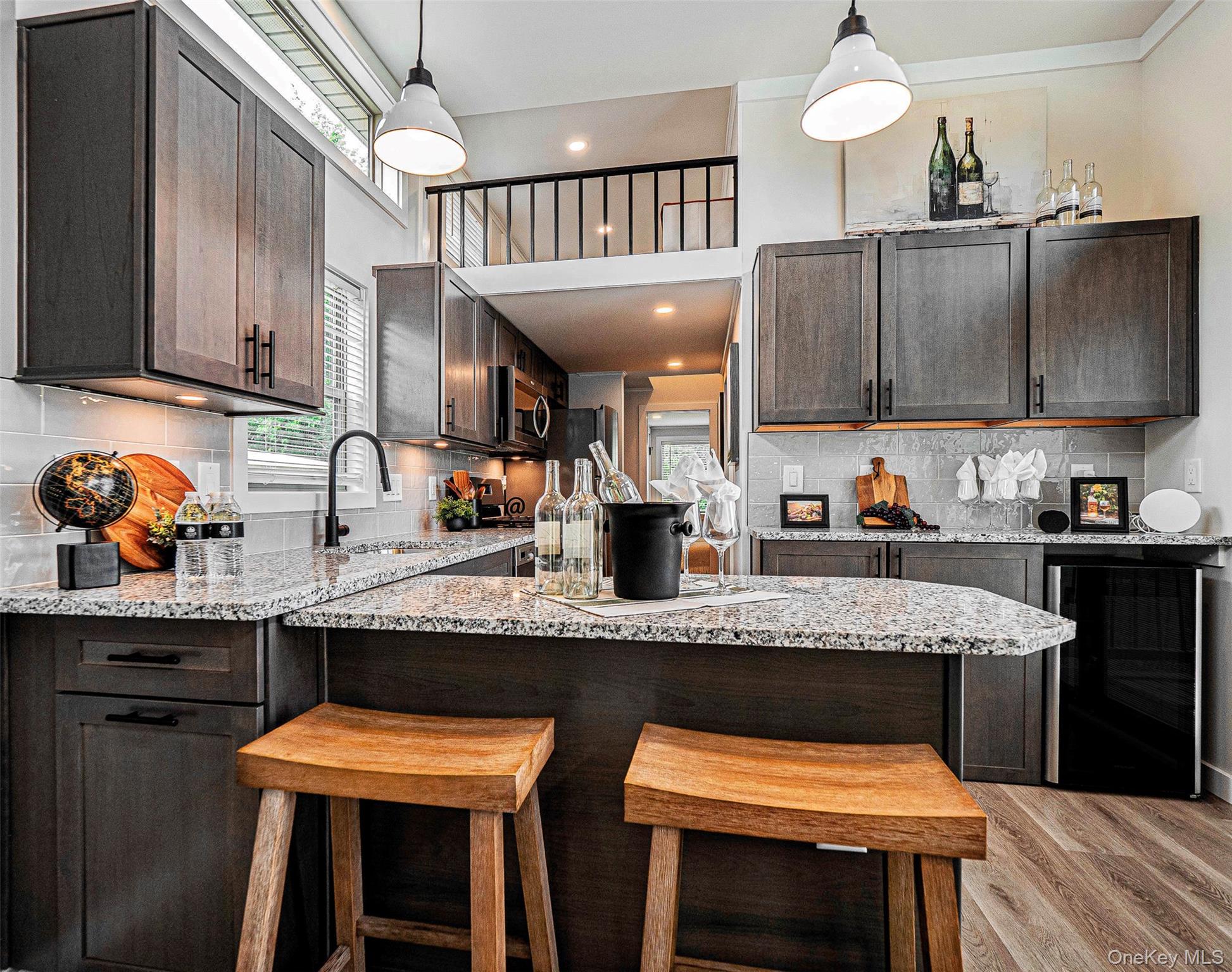 197 Wheeler Road, Unit 91 Florida, NY 10921 - Photo 8 of 42 Kitchen with tasteful backsplash, dark brown cabinetry, wine cooler, light stone countertops, and recessed lighting