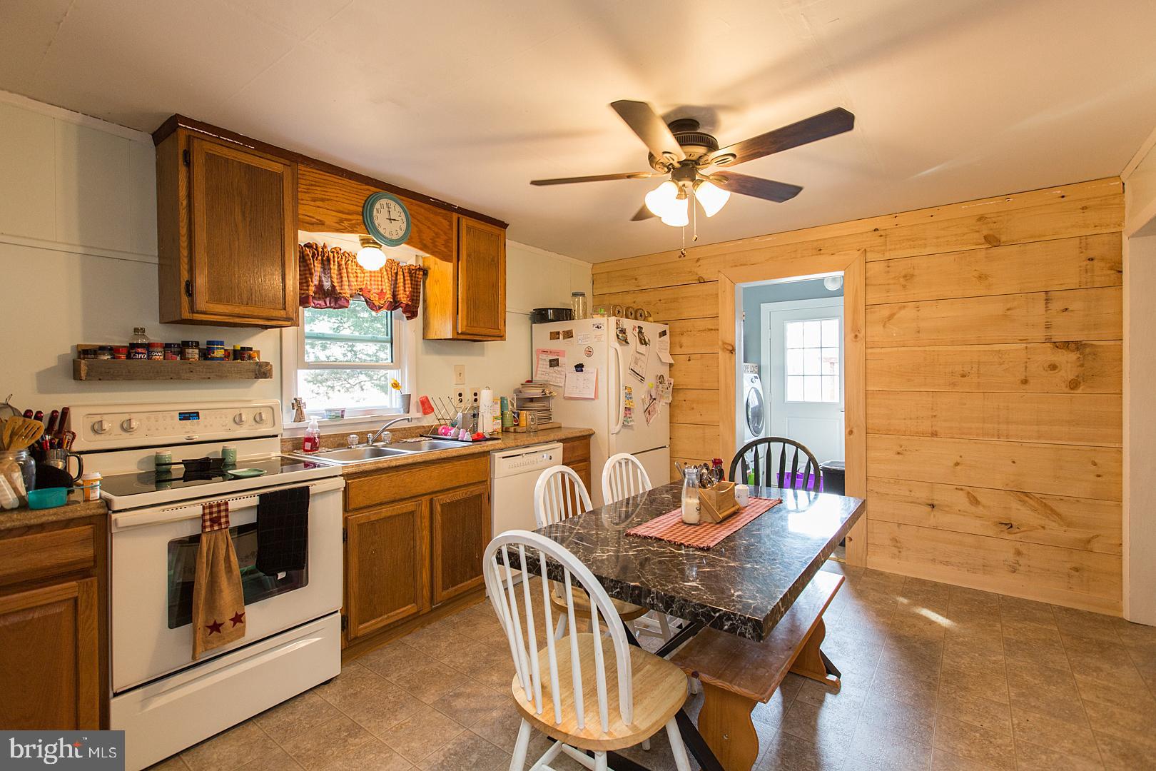 38 Fulton View Road Quarryville, PA 17566 - Photo 14 of 42 a kitchen with stainless steel appliances granite countertop a stove a sink dishwasher and a dining table with cabinets