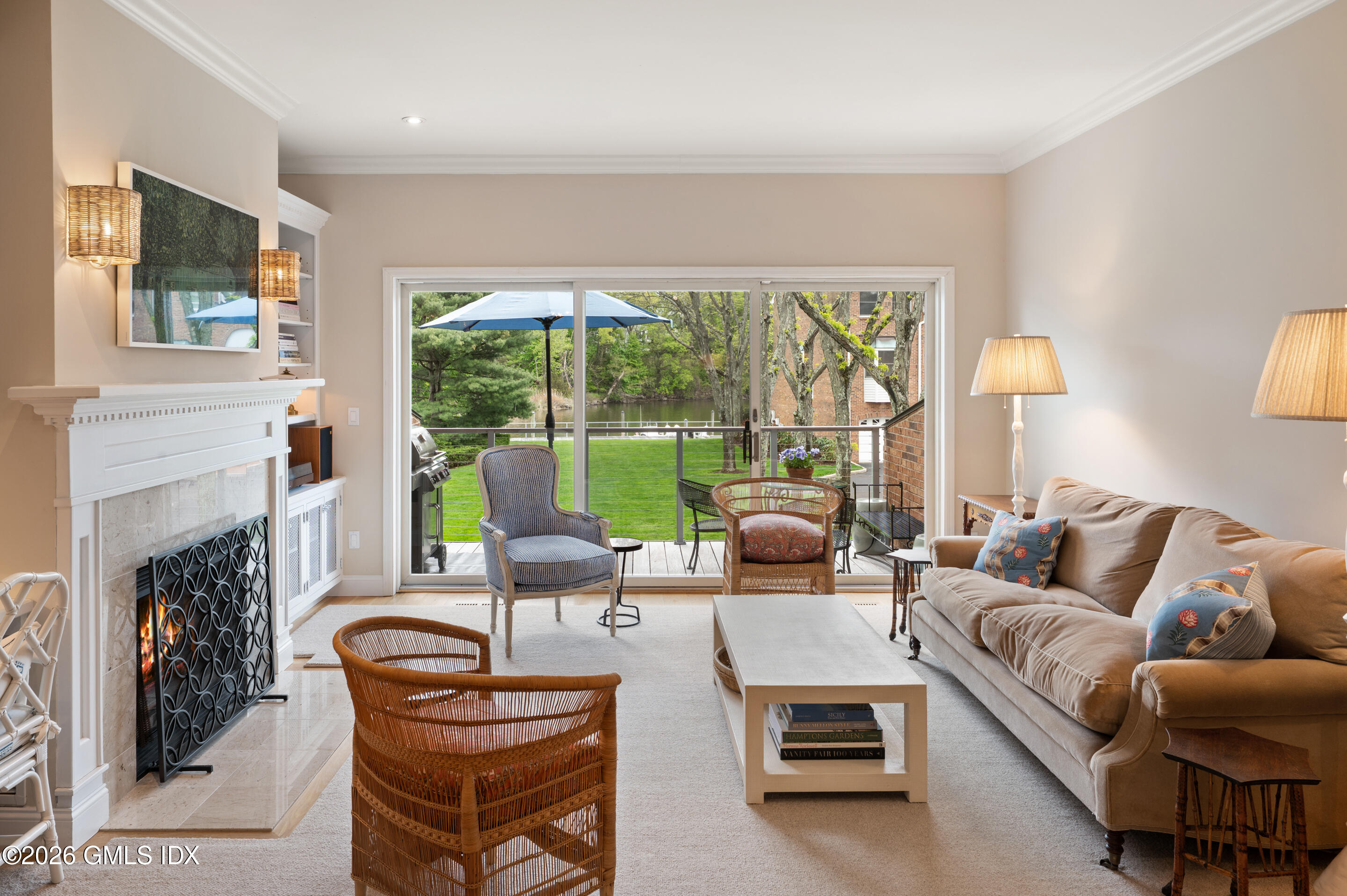 a living room with furniture a fireplace and a large window