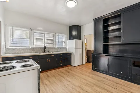 a kitchen with a refrigerator stove and sink