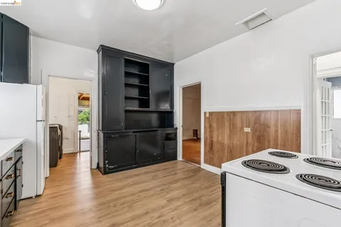 a kitchen with a refrigerator and a stove top oven