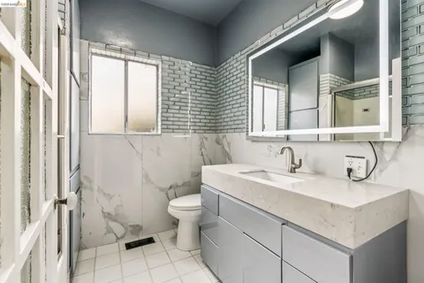 a bathroom with a sink toilet a mirror and vanity