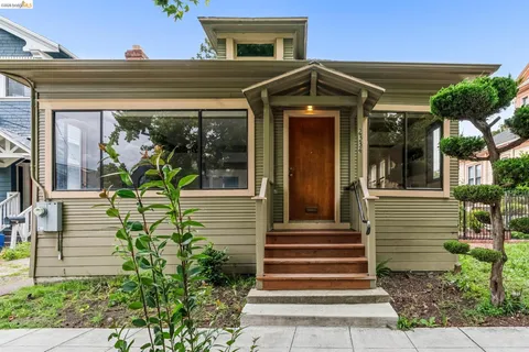 a front view of a house with potted plants