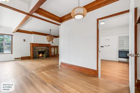 an empty room with wooden floor and a fireplace