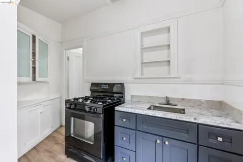 a kitchen with granite countertop a stove and a sink