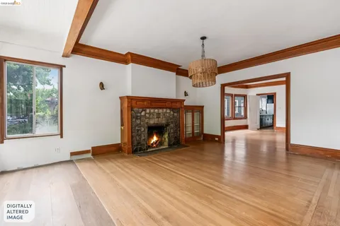 a view of an empty room with a fireplace and a window
