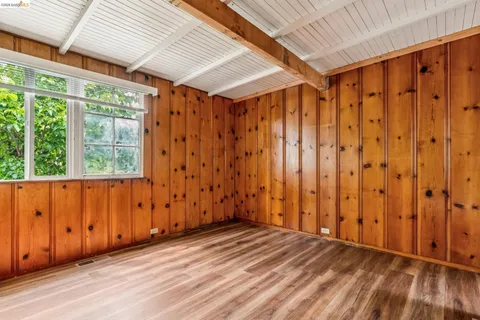 a view of wooden floor and windows in a room
