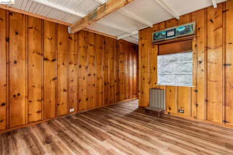 a view of a door with wooden floor and a window