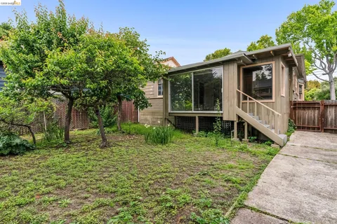 a view of house with backyard space and garden