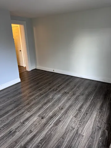 a view of a room with wooden floor and window