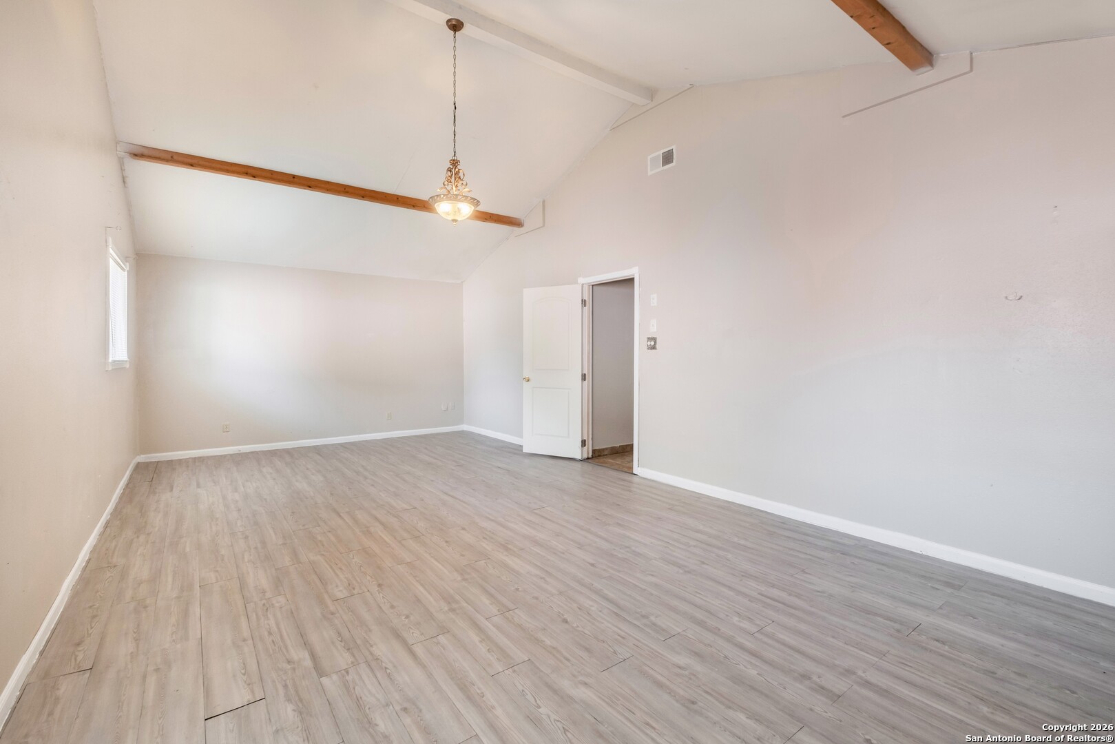 5207 Overpool Street San Antonio, TX 78228 - Photo 13 of 31 an empty room with wooden floor and windows